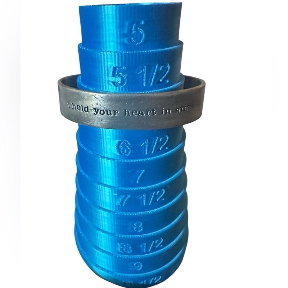 Lisa Leonard silver “I hold your heart in mine” cuff bracelet.